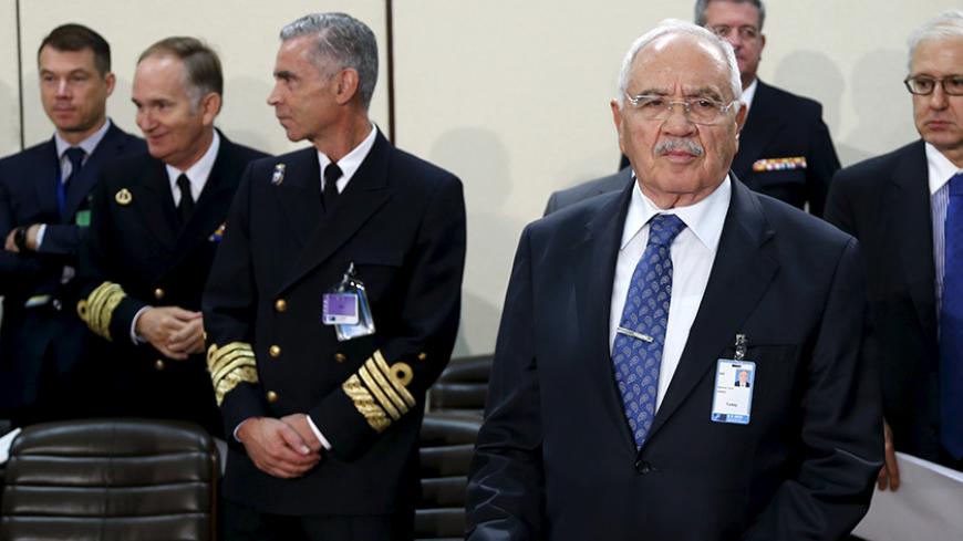 Turkish Defence Minister Mehmet Vecdi Gonul (front R) waits for the start of a NATO defence ministers meeting at the Alliance headquarters in Brussels, Belgium October 8, 2015. NATO said it was prepared to send troops to Turkey to defend its ally after violations of Turkish airspace by Russian jets bombing Syria and Britain scolded Moscow for escalating a civil war that has already killed 250,000 people.  REUTERS/Francois Lenoir     - RTS3J5P