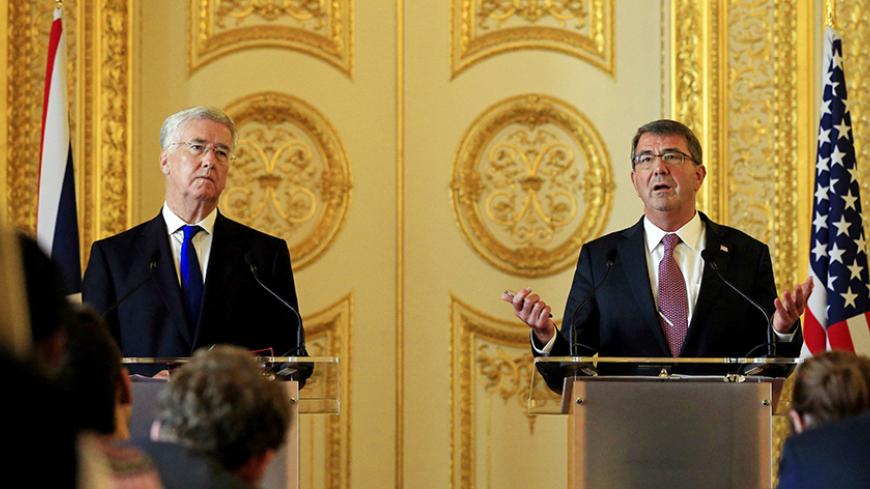 U.S. Defence Secretary Ashton Carter (R) speaks during a news conference with his British counterpart Michael Fallon at Lancaster House in London, Britain October 9, 2015. U.S. President Barack Obama will overhaul Washington's approach to supporting Syrian rebel forces following this year's deeply troubled launch of a U.S. military training program, Carter said on Friday. REUTERS/Jonathan Brady/pool - RTS3QRE