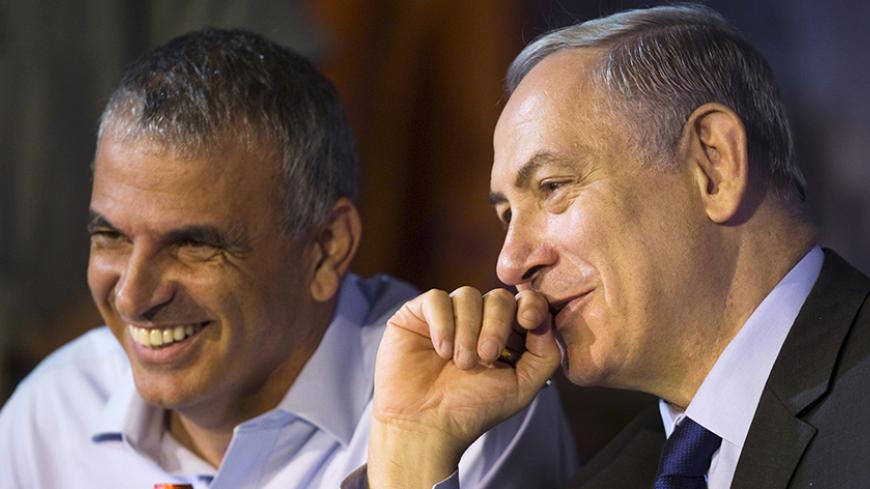 Israeli Prime Minister Benjamin Netanyahu (R) and Finance Minister Moshe Kahlon smile during a signing ceremony for new housing units in the southern city of Ashkelon, Israel October 29, 2015. REUTERS/Amir Cohen - RTX1TUVN