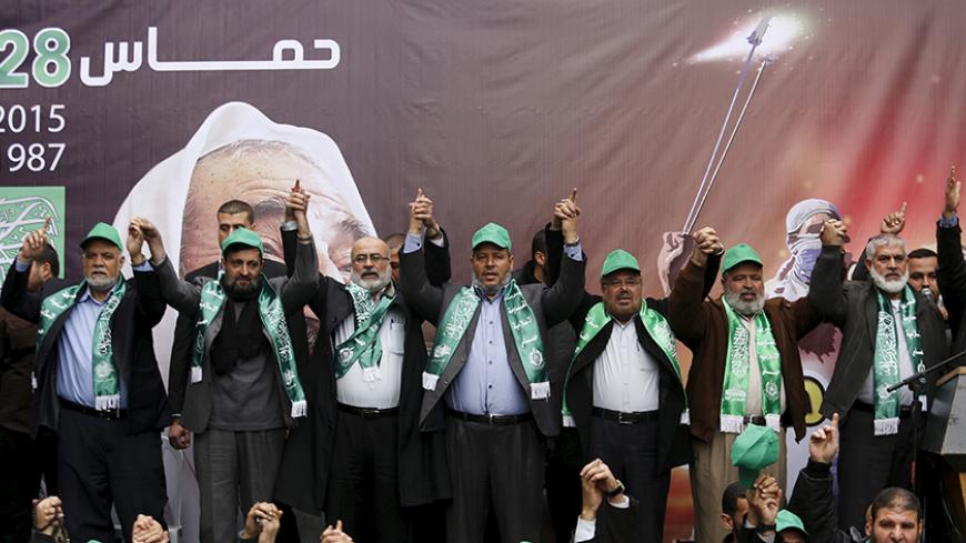 Hamas leaders (top) join hands as they take part in a rally marking the 28th anniversary of Hamas' founding, in Gaza City December 14, 2015. REUTERS/Suhaib Salem - RTX1YLNB