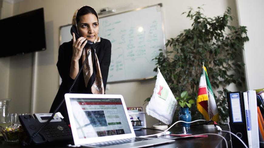 Iranian Nazanin Daneshvar, founder of Takhfifan startup company speaks on the phone in her office in Tehran on July 1, 2015. Women are more likely to start businesses. Very present in senior positions of the Islamic Republic, they are needed in the private sector. It is a continuous parade in office Nazanin Daneshvar. Commerce Site Online Takhfifan Founder - "discount", in Farsi - the young woman engineer in turn receives foreign visitors, journalists and business leaders from discovering Iran before the li