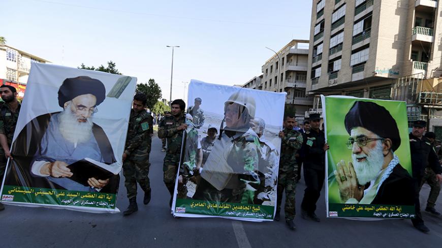 Members from Hashid Shaabi hold portraits of lawmaker and paramilitary commander Hadi al-Amiri (C), Iran's Supreme Leader Ayatollah Ali Khamenei (R) and Iraq's top Shi'ite cleric Grand Ayatollah Ali al-Sistani (L) during a demonstration to show support for Yemen's Shi'ite Houthis and in protest of an air campaign in Yemen by a Saudi-led coalition, in Baghdad March 31, 2015. Saudi troops clashed with Yemeni Houthi fighters on Tuesday in the heaviest exchange of cross-border fire since the start of a Saudi-le