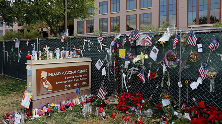 A memorial still remains outside as workers return to work for the first time at the Inland Regional Center (IRC) in San Bernardino, California, January 4, 2016. The office building in San Bernardino, California, where 14 people were massacred last month by a married couple inspired by Islamist militants, reopened on Monday. Syed Rizwan Farook and his wife, Tashfeen Malik, stormed into a holiday party attended by his co-workers from a San Bernardino County social services agency and opened fire on Dec. 2, k
