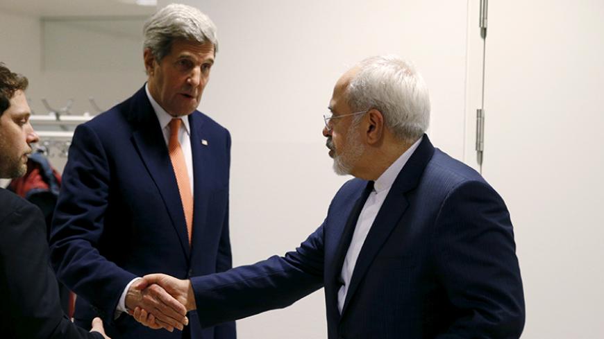 U.S. Secretary of State John Kerry shakes hands with Iranian Foreign Minister Mohammad Javad Zarif after the International Atomic Energy Agency (IAEA) verified that Iran has met all conditions under the nuclear deal, in Vienna January 16, 2016.  REUTERS/Kevin Lamarque      TPX IMAGES OF THE DAY      - RTX22P8Q