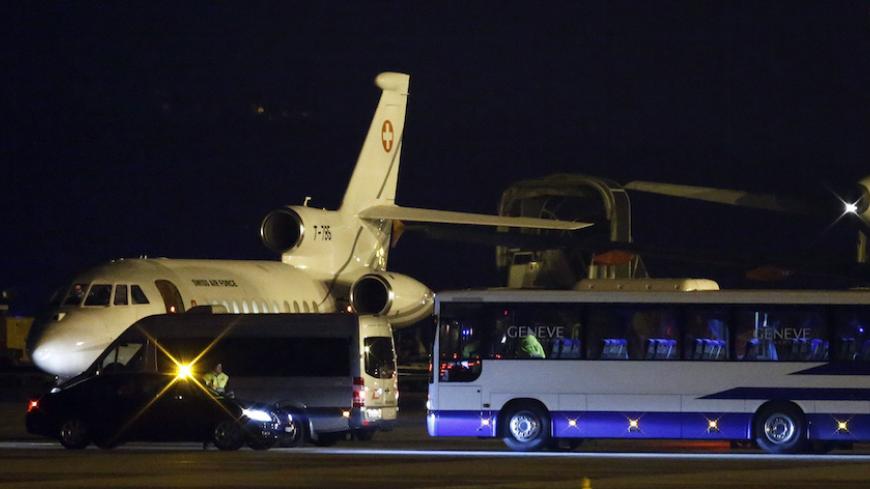 A bus and a van are parcked in front of a plane carrying three Iranian-Americans, who left Tehran under a prisoner swap, after it landed at Cointrin airport in Geneva, Switzerland January 17, 2016.  REUTERS/Denis Balibouse - RTX22RUH