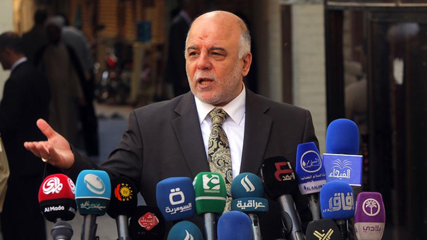 Iraqi Prime Minister Haider al-Abadi speaks to reporters after a meeting with the top Shiite cleric, Grand Ayatollah Ali al-Sistani, in the Shiite holy city of Najaf, south of Baghdad, October 20, 2014.  REUTERS/Alaa Al-Marjani (IRAQ - Tags: POLITICS RELIGION) - RTR4AVJG