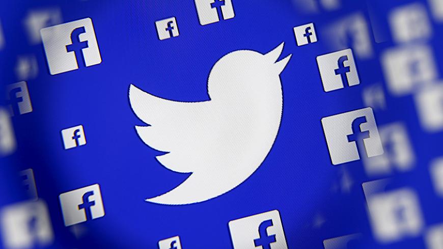 Logo of the Twitter and Facebook are seen through magnifier on display in this illustration taken in Sarajevo, Bosnia and Herzegovina, December 16, 2015. Broker's survey shows Twitter losing share to faster growing competitors such as Facebook's Instagram and Snapchat, despite co's multiple product and partnership launches this year, analysts write in note. REUTERS/Dado Ruvic - RTX1Z12A