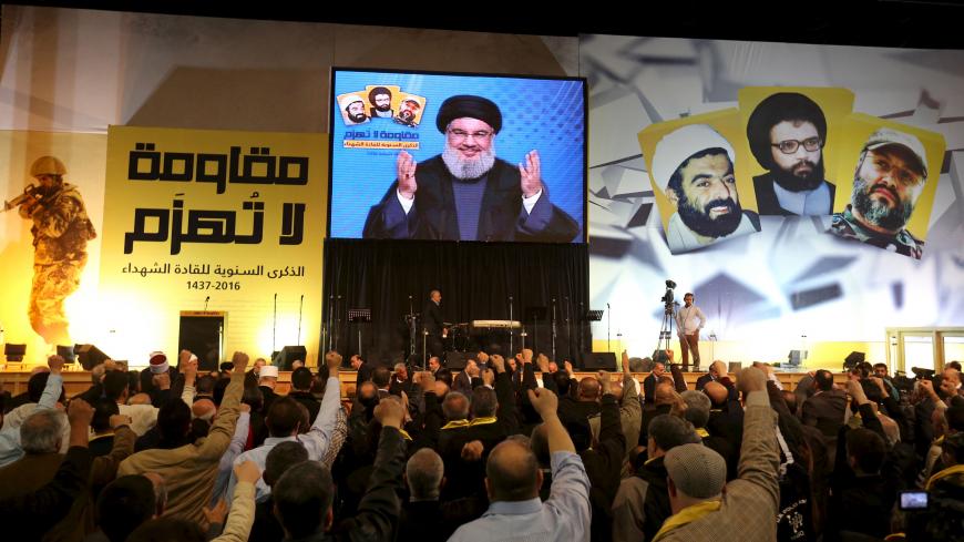 Lebanon's Hezbollah leader Sayyed Hassan Nasrallah addresses his supporters through a giant screen during a rally commemorating the annual Hezbollah Martyrs' Leader Day in Beirut's southern suburbs, Lebanon February 16, 2016. REUTERS/Aziz Taher - RTX278R4