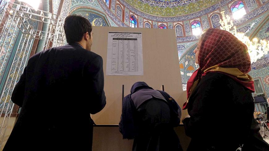 Iranians look at a list of candidates' names during elections for the parliament and Assembly of Experts, which has the power to appoint and dismiss the supreme leader, at a polling station in Tehran February 26, 2016. REUTERS/Raheb Homavandi/TIMA  ATTENTION EDITORS - THIS IMAGE WAS PROVIDED BY A THIRD PARTY. FOR EDITORIAL USE ONLY. - RTX28NK7