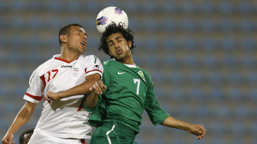 Yaghoub Karimi of Iran (L) challenges Husain Al Moqahwi of Saudi Arabia during their WAFF Championship soccer match in Kuwait City December 9, 2012. REUTERS/Stringer (KUWAIT - Tags: SPORT SOCCER) - RTR3BEA1