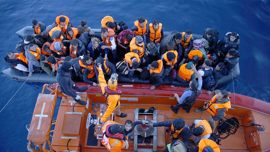 Refugees and migrants board Turkish Coast Guard Search and Rescue ship Umut-703 after a failed attempt of crossing to the Greek island of Chios off the shores of Izmir, Turkey, February 28,  2016. Picture taken February 28, 2016. REUTERS/Umit Bektas - RTS8JJY