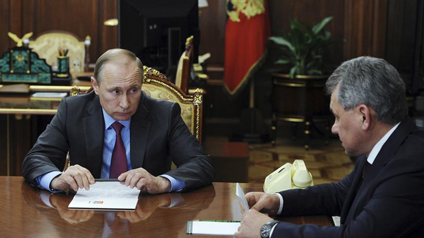 Russian President Vladimir Putin talks with Defence Minister Sergei Shoigu at the Kremlin in Moscow, Russia, March 14, 2016. REUTERS/Mikhail Klimentyev/Sputnik/Kremlin     ATTENTION EDITORS - THIS IMAGE HAS BEEN SUPPLIED BY A THIRD PARTY. IT IS DISTRIBUTED, EXACTLY AS RECEIVED BY REUTERS, AS A SERVICE TO CLIENTS.      TPX IMAGES OF THE DAY      - RTX294YM