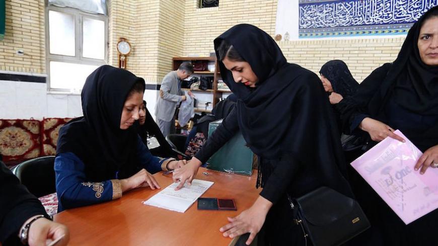 An Iranian woman casts her ballot to vote in the second round of parliamentary elections at a polling station in the town of Robat Karim, some 40 kms southwest of the capital Tehran, on April 29, 2016.
Iranians started voting in second round elections for almost a quarter of parliament's seats, the latest political showdown between reformists and conservatives seeking to influence the country's future. Polling stations opened at 8:00 am (0330 GMT) for the ballot which is taking place in 21 provinces, but no