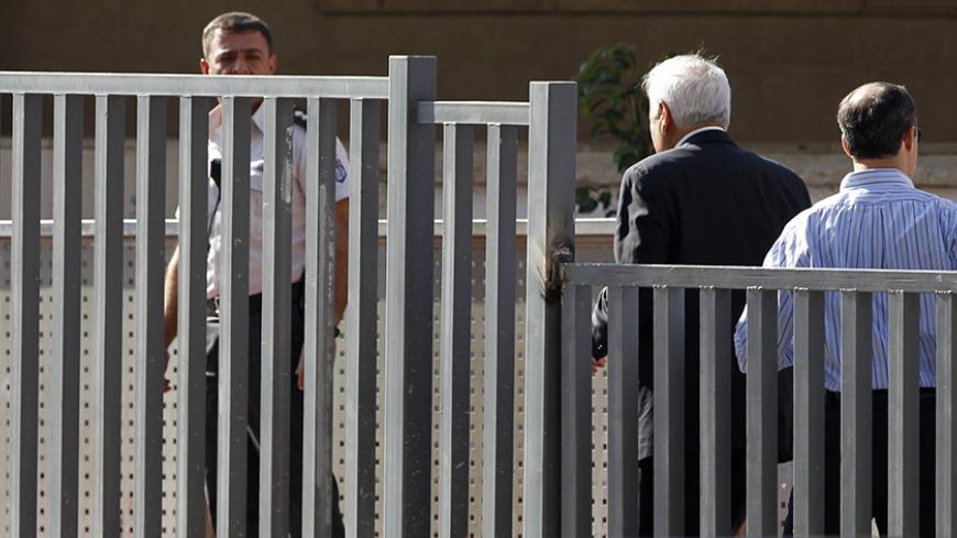 Former Israeli president Moshe Katsav (2nd R) walks towards the entrance to Maasiyahu prison in Ramle, near Tel Aviv, December 7, 2011.  Katsav began serving a seven-year prison term for rape on Wednesday, professing his innocence and saying he was being "buried alive". The case has captivated the country for more than five years and marked the first time a former Israeli head of state has been jailed. Officials say it proves no one is above the law. REUTERS/Baz Ratner (ISRAEL - Tags: POLITICS CRIME LAW) - 