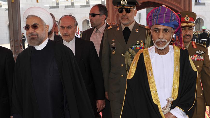 Oman's Sultan Qaboos bin Said (R) walks with Iran's President Hassan Rouhani upon Rouhani's arrival in Muscat March 12, 2014. REUTERS/Sultan Al Hasani (OMAN - Tags: POLITICS ROYALS) - RTR3GQAH