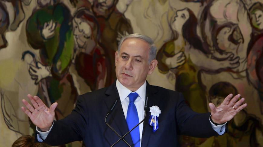 Israel's Prime Minister Benjamin Netanyahu gestures as he speaks at an event following the swearing-in ceremony of the 20th Knesset, the new Israeli parliament, in Jerusalem March 31, 2015. Netanyahu said on Tuesday the framework Iranian nuclear agreement being sought by international negotiators will leave Iran with the capability to develop a nuclear weapon in under a year. REUTERS/Gali Tibbon/Pool  - RTR4VMVY