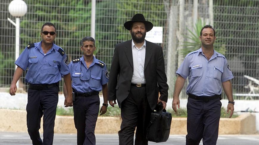 Former Israeli government kingmaker and ex-leader of the ultra-orthodox
Shas Party Aryeh Deri is escorted by policemen as he walks out of
prison July 15, 2002 after serving two years of a three-years sentence
for corruption. Deri, released a year early for "good behaviour", said
he would devote himself to social work and that he would seek a
retrial. REUTERS/Nir Elias

NIR/RS - RTR7NTA