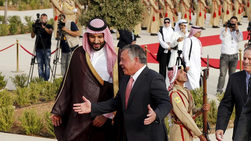 Jordan's King Abdullah (2nd L) speaks with Saudi Arabia's Deputy Crown Prince Mohammed bin Salman (L), upon his arrival at the Royal Palace in Amman, Jordan, August 4, 2015. REUTERS/Muhammad Hamed - RTX1N1G0