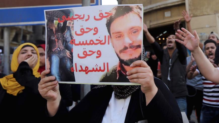 An Egyptian activist holds a poster calling for justice to be done in the case of the recently murdered Italian student Giulio Regeni during a demonstration protesting the government's decision to transfer two Red Sea islands to Saudi Arabia, in front of the Press Syndicate in Cairo, Egypt, April 15, 2016.  REUTERS/Mohamed Abd El Ghany - RTX2A55T