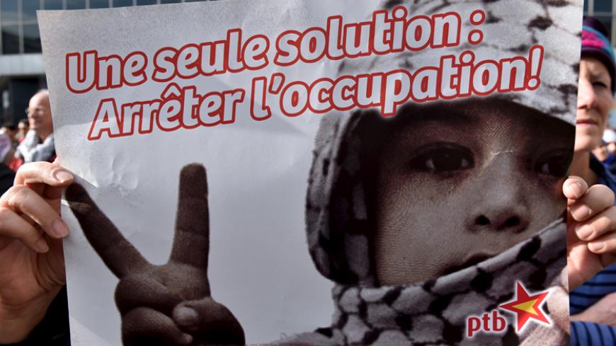 A protester holds a sign, which reads: "Only one solution: stop occupation", during a demonstration in solidarity with Palestinians, in Brussels, Belgium, October 18, 2015. REUTERS/Eric Vidal - RTS4Z1P