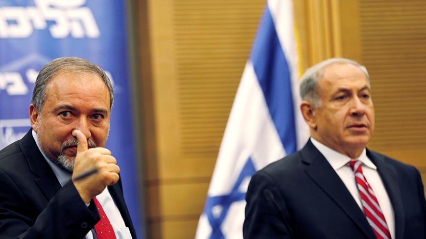 Israel's Prime Minister Benjamin Netanyahu (R) and Avigdor Lieberman attend a Likud-Beitenu faction meeting at the Knesset, the Israeli parliament, in Jerusalem November 11, 2013. REUTERS/Amir Cohen/File Photo - RTSFIT8
