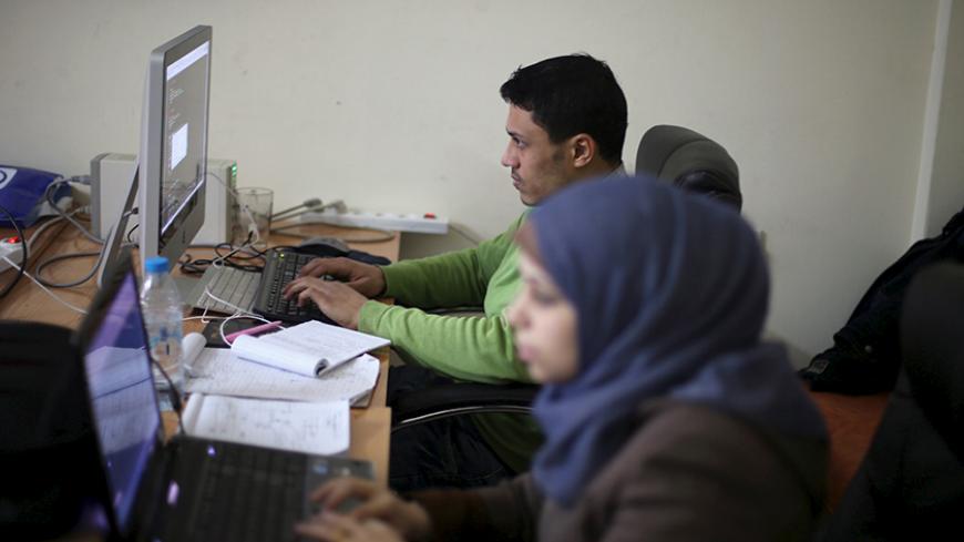 Young Palestinian entrepreneurs use their computers at Gaza Sky Geeks office, in Gaza City January 18, 2016. Picture taken January 18, 2016. REUTERS/Ibraheem Abu Mustafa  - RTX242SL