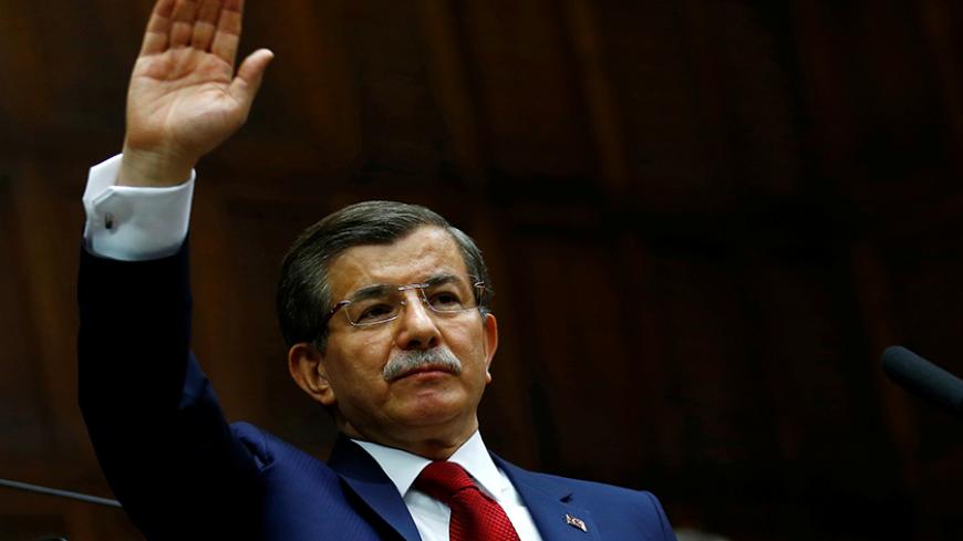 Turkey's Prime Minister Ahmet Davutoglu greets members of parliament from his ruling AK Party (AKP) as he arrives a meeting at the Turkish parliament in Ankara, Turkey, May 3, 2016. REUTERS/Umit Bektas - RTX2CLC7