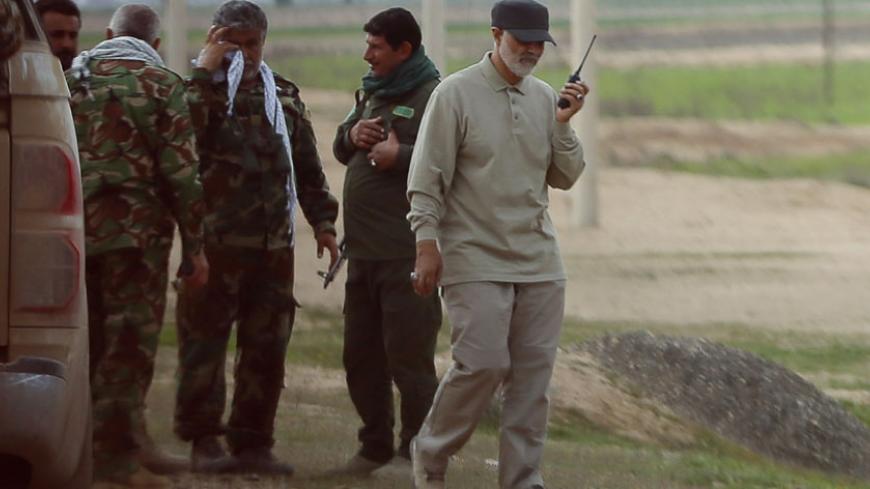 Iranian Revolutionary Guard Commander Qassem Soleimani uses a walkie-talkie at the frontline during offensive operations against Islamic State militants in the town of Tal Ksaiba in Salahuddin province March 8, 2015. Picture taken March 8, 2015.   REUTERS/Stringer (IRAQ - Tags: CIVIL UNREST CONFLICT POLITICS) - RTR4TU0N