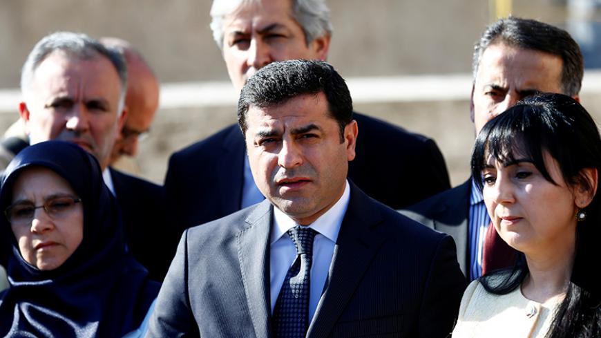 Co-chairs of the pro-Kurdish Peoples' Democratic Party (HDP), Selahattin Demirtas and Figen Yuksekdag (R), are flanked by fellow lawmakers as they attend a news conference at the entrance of the Turkish parliament in Ankara, Turkey, May 20, 2016. REUTERS/Umit Bektas     TPX IMAGES OF THE DAY      - RTSF6OZ