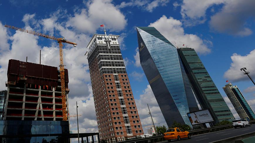 Finansbank headquarters is seen between Tekfen (2nd L) and Sapphire (R) towers in Istanbul, Turkey, June 9, 2016. REUTERS/Murad Sezer - RTSGPQH