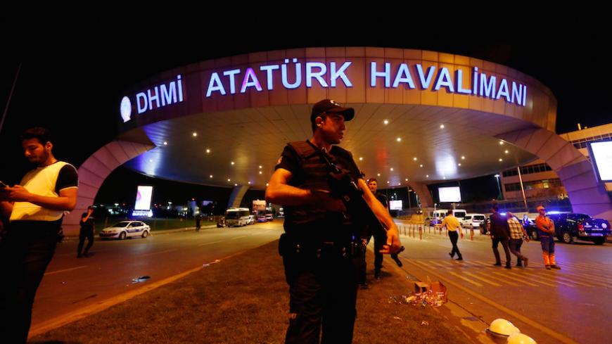 A riot police officer stands guard at the entrance of the Ataturk airport in Istanbul, Turkey, following a multiple suicide bombing, early June 29, 2016. REUTERS/Murad Sezer - RTX2IS3C