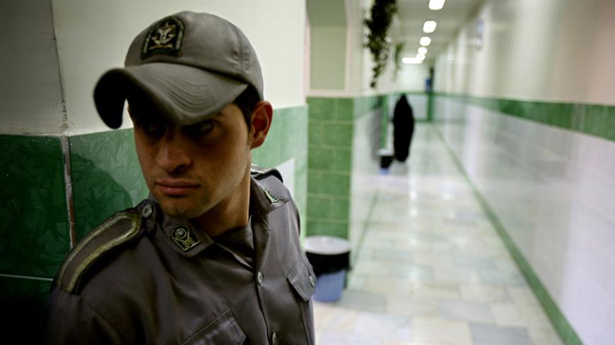 A prison guard stands along a corridor in Tehran's Evin prison June 13, 2006. Iranian police detained 70 people at a demonstration in favour of women's rights, the judiciary said on Tuesday, adding it was ready to review reports that the police had beaten some demonstrators. - RTXOQWJ