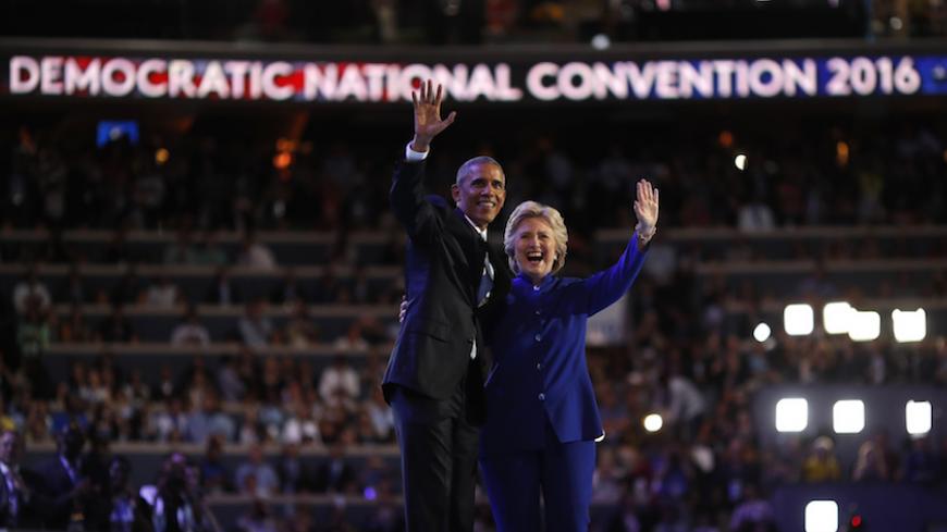 U.S. President Barack Obama and Democratic presidential nominee Hillary Clinton appear onstage together after his speech on the third night at the Democratic National Convention in Philadelphia, Pennsylvania, U.S. July 27, 2016. REUTERS/Carlos Barria - RTSK0DG