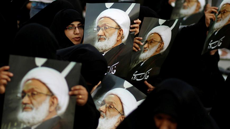 Supporters hold posters of Bahrain's leading Shi'ite cleric Isa Qassim during a sit-in outside his home in the village of Diraz west of Manama, Bahrain June 21, 2016.  REUTERS/Hamad I Mohammed     TPX IMAGES OF THE DAY      - RTX2HIPR