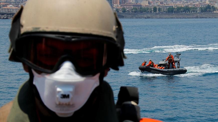 German Navy soldiers take part in a drill for a search and rescue operation during the visit of German Defence Minister Ursula von der Leyen aboard the German navy vessel Schleswig Holstein near the harbour of the Sicilian port city of Catania, Italy, July 4, 2015. REUTERS/Fabrizio Bensch/File Photo - RTX2HJGL