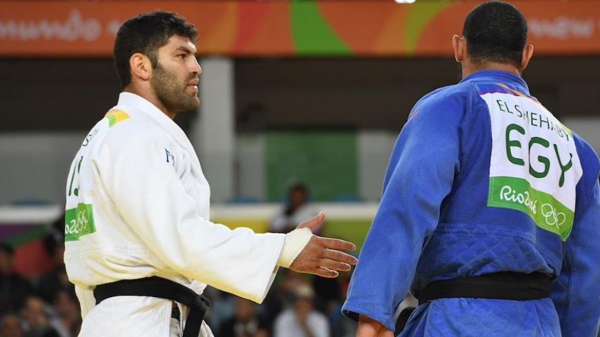 Israel's Or Sasson (white) competes with Egypt's Islam Elshehaby during their men's +100kg judo contest match of the Rio 2016 Olympic Games in Rio de Janeiro on August 12, 2016. / AFP / Toshifumi KITAMURA        (Photo credit should read TOSHIFUMI KITAMURA/AFP/Getty Images)
