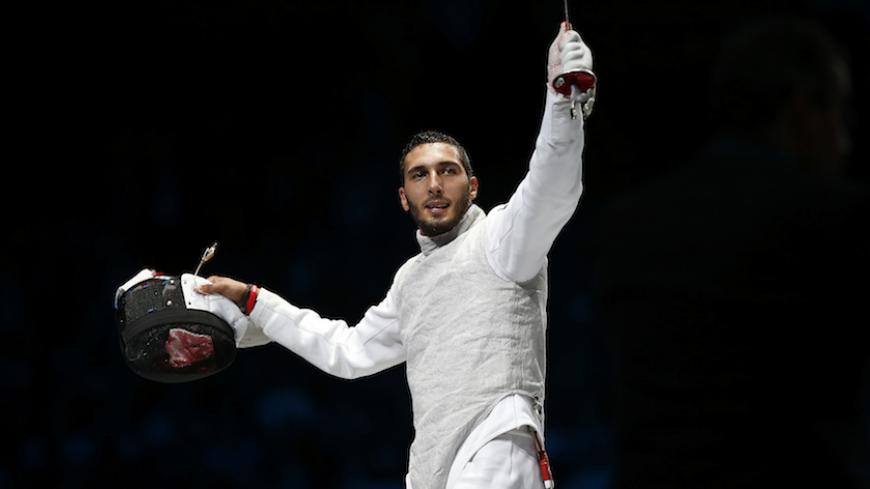 Egypt's Alaaeldin Abouelkassem celebrates defeating South Korea's Choi Byungchul during their men's individual foil semifinal fencing match at the ExCel venue at the London 2012 Olympic Games July 31, 2012.                     REUTERS/Damir Sagolj (BRITAIN  - Tags: SPORT OLYMPICS SPORT FENCING)   - RTR35RLX