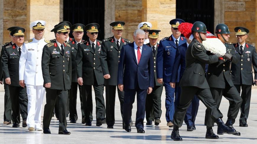 Turkey's Prime Minister Binali Yildirim (C), flanked by Chief of Staff General Hulusi Akar (3rd L)  and the country's top generals, attends a wreath-laying ceremony in Anitkabir, the mausoleum of modern Turkey's founder Mustafa Kemal Ataturk, ahead of a High Military Council meeting in Ankara, Turkey, July 28, 2016. REUTERS/Umit Bektas - RTSK1HV