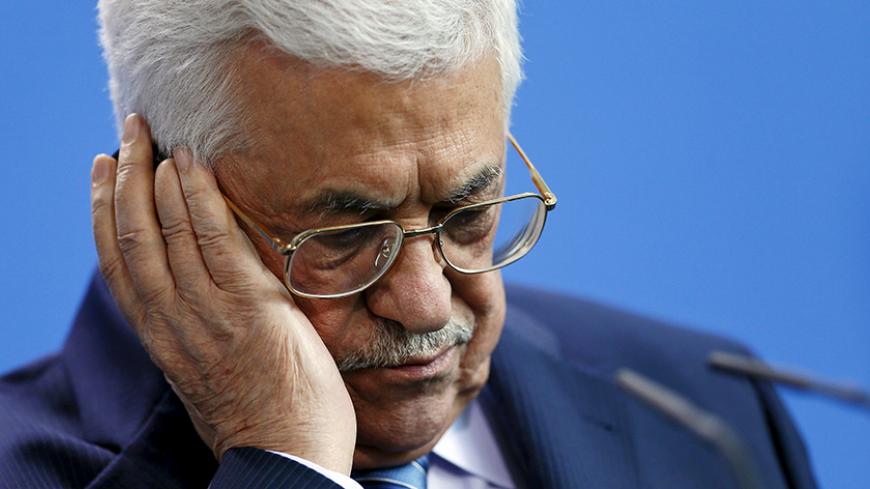 Palestinian President Mahmoud Abbas listens through headphones during a news conference with Chancellor Angela Merkel (unseen) at the Chancellery in Berlin, Germany, April 19, 2016. REUTERS/Hannibal Hanschke  - RTX2AOLK