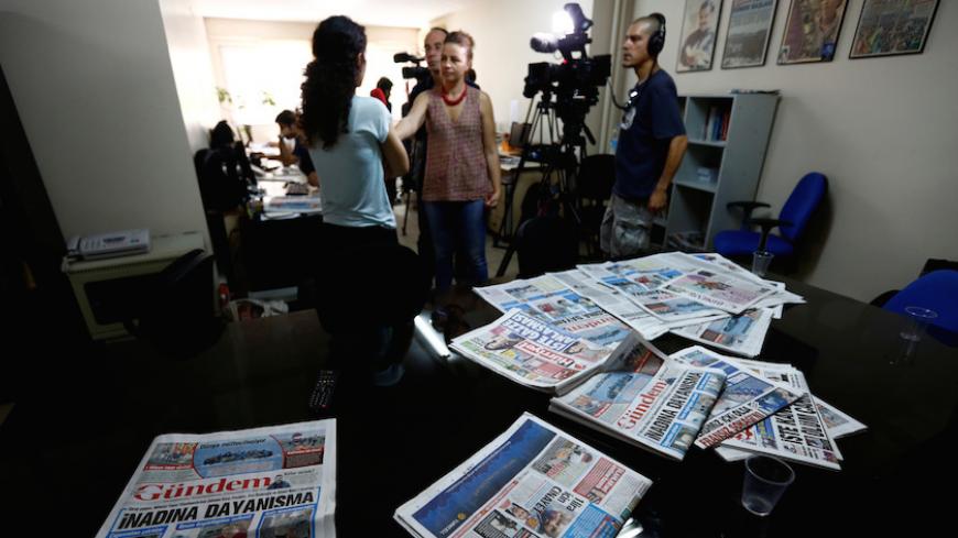 A journalist of pro-Kurdish Ozgur Gundem gives an interview to a German TV channel at their newsroom before a protest against the arrest of three prominent campaigners for press freedom, in front of the pro-Kurdish Ozgur Gundem newspaper in central Istanbul, Turkey, June 21, 2016. REUTERS/Murad Sezer - RTX2HD1N