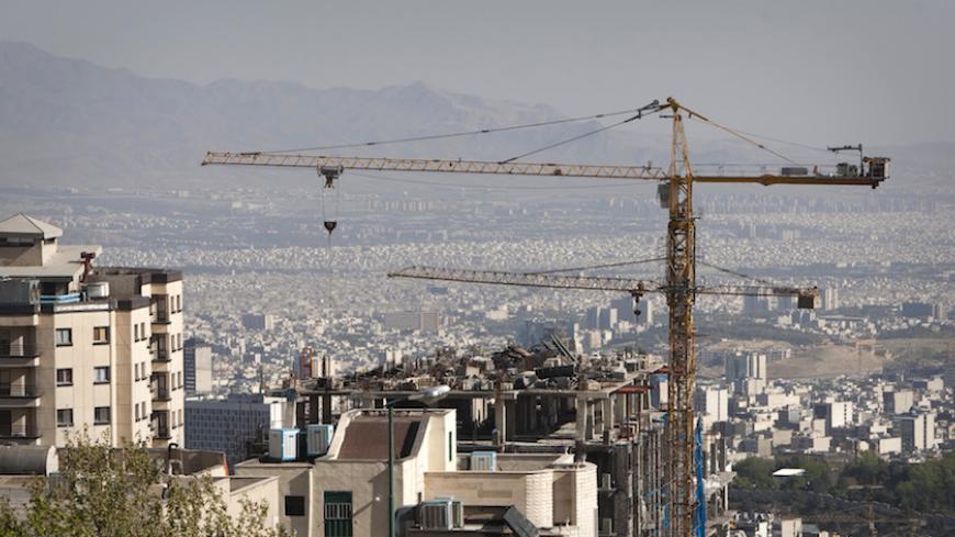 EDITORS' NOTE: Reuters and other foreign media are subject to Iranian restrictions on their ability to report, film or take pictures in Tehran. 

Construction cranes work on a high rise buildings in the foothills of the Alborz mountains in north Tehran April 15, 2010. President Mahmoud Ahmadinejad has asked 5 million Tehranis to evacuate the capital since they know their sprawling metropolis is due for a massive earthquake. When the last major earthquake hit, in 1831, Tehran was tiny compared to the metropo