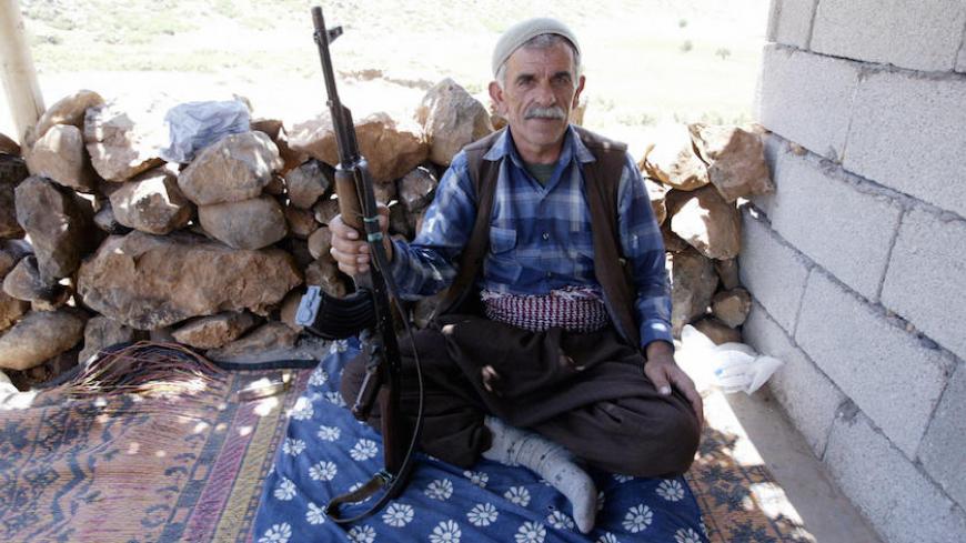 Siirt, TURKEY:  A village guard poses with his rifle in his cabin in the mountainous southeastern city of Siirt, Pervari province, 28 June 2005. The outlawed Kurdistan Worker's Party (PKK) retaliated by blowing up a train in Bingol at the weekend, killing five people. The unrest marks sharply increased violence between the PKK and the army in the Turkish southeast since April, months after the rebels, 01 June 2004, called off a five-year unilateral ceasefire.         AFP PHOTO/MUSTAFA OZER  (Photo credit sh