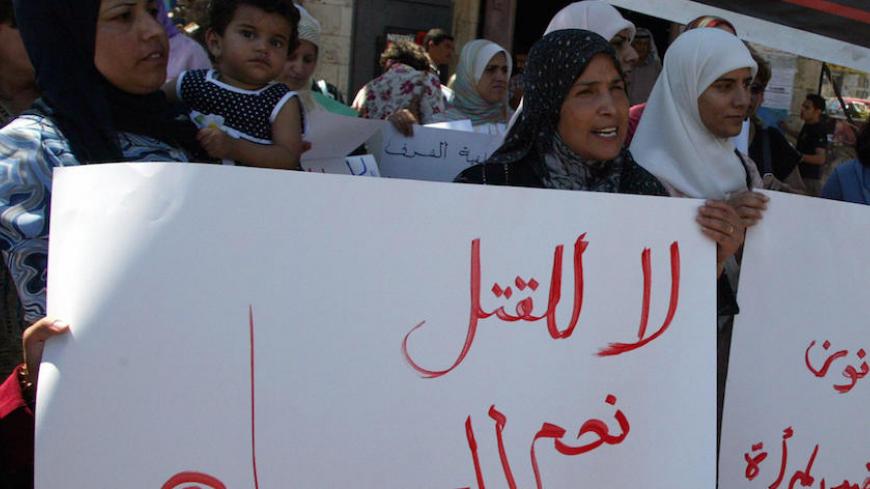RAMALLAH, -:  Palestinian women hold up banners reading "No to killing, yes to life" as they demonstrate against the "crimes of honor" in some traditional and rural Palestinian communities in which female vitue and virginity still defines a family's reputation, 10 September 2005 in Ramallah. Honor killing in some Arab societies occurrs when women accused in sexual misconduct are murdered by close relatives who are encourged by their families to "cleanse" the honor of the family that has been "disgraced." AF