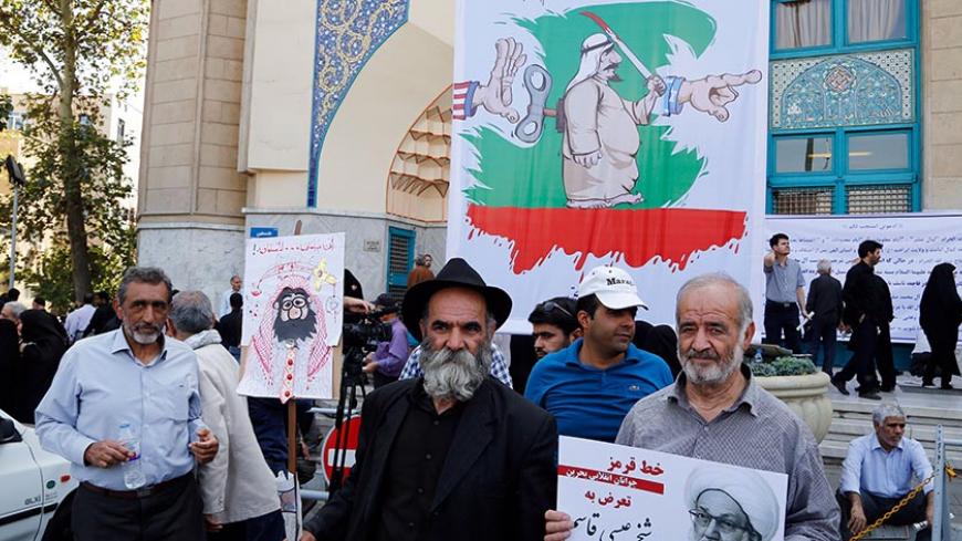 Iranian men holding a picture Bahraini Shiite cleric Sheikh Isa Qassim (R) and a caricature of the Saudi king, participate in an anti-Saudi demonstration in the capital Tehran on September 9, 2016.
With Iranians barred from the annual hajj pilgrimage, thousands protested in Tehran and officials criticised Saudi Arabia's refusal to discuss last year's deadly stampede during which more than 400 Iranians were among the nearly 2,300 pilgrims that were killed. The writing on the posters in Arabic read "Malicious