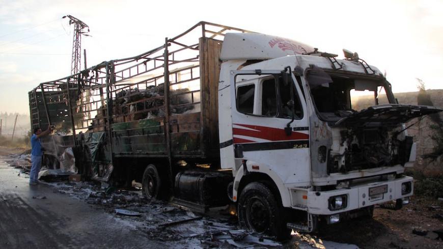 A damaged truck carrying aid is seen on the side of the road in the town of Orum al-Kubra on the western outskirts of the northern Syrian city of Aleppo on September 20, 2016, the morning after a convoy delivering aid was hit by a deadly air strike.
The UN said at least 18 trucks in the 31-vehicle convoy were destroyed en route to deliver humanitarian assistance to the hard-to-reach town.
 / AFP / Omar haj kadour        (Photo credit should read OMAR HAJ KADOUR/AFP/Getty Images)