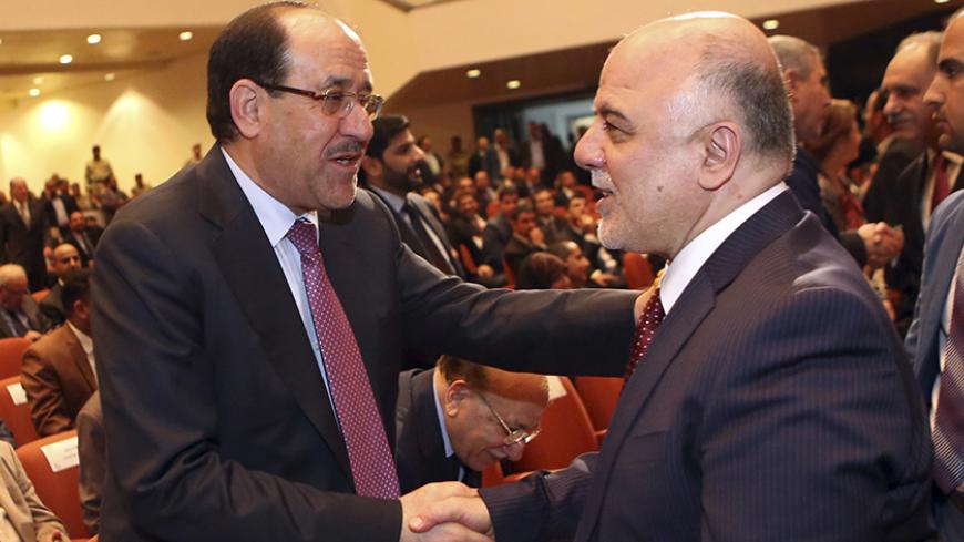 Iraq's Vice President Nouri al-Maliki (L) and new Prime Minister Haider al-Abadi shake hands during the session to approve the new government in Baghdad, September 8, 2014.Iraq's parliament approved a new government headed by Haider al-Abadi as prime minister on Monday night, in a bid to rescue Iraq from collapse, with sectarianism and Arab-Kurdish tensions on the rise. REUTERS/Hadi Mizban/Pool (IRAQ - Tags: POLITICS) - RTR45G35