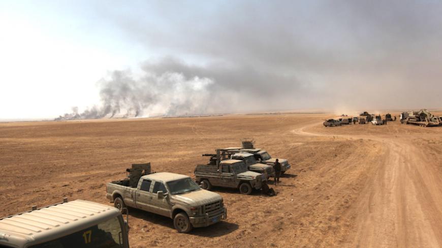 Military vehicles of the Kurdish Peshmerga forces are seen on the southeast of Mosul , Iraq, August 14, 2016. REUTERS/Azad Lashkari - RTX2KS2U
