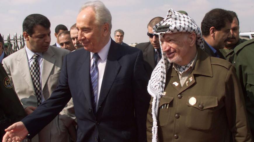 Israeli Foreign Minister Shimon Peres ( L) and Palestinian President Yasser Arafat (R) arrive for a meeting at the Gaza airport in Rafah September 26, 2001. Arafat and Peres met for a long awaited meeting to discuss steps to a peace agreement between Israel and the Palestinians. - RTXKROT