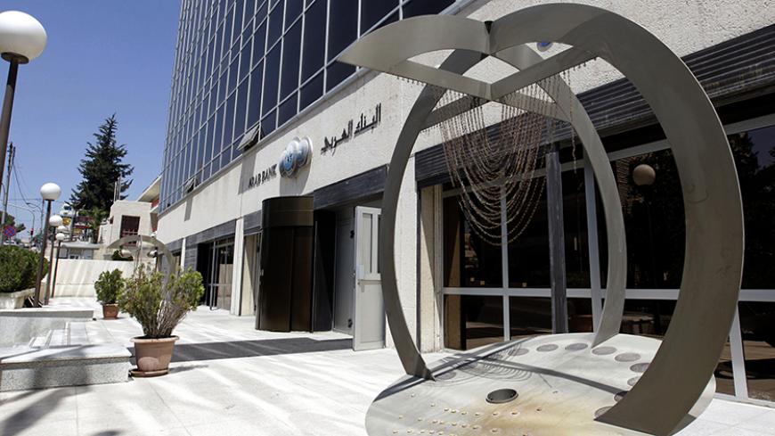 A picture taken on August 16, 2014 shows the entrance of Arab Bank's main offices in the Jordanian capital, Amman. Jordan's Arab Bank went on trial on August 15, 2014 in New York accused of aiding terror by transferring support funds to the families of Palestinians who died in the conflict with Israel. The families of several Americans killed in early 2000s attacks by the Islamic movement Hamas said the bank, which has a New York branch, was in violation of the 2001 Anti-Terrorism Act when it served as a co