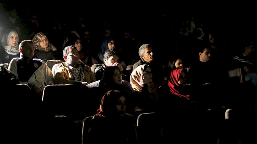 Palestinian spectators watch a movie at Red Crescent Society hall in Gaza City February 25, 2016. Palestinians in the Gaza Strip are enjoying their first night out at the movies since political tensions led to the torching of cinemas in the enclave 20 years ago.  Picture taken February 25, 2016. REUTERS/Mohammed Salem  - RTS8KNE